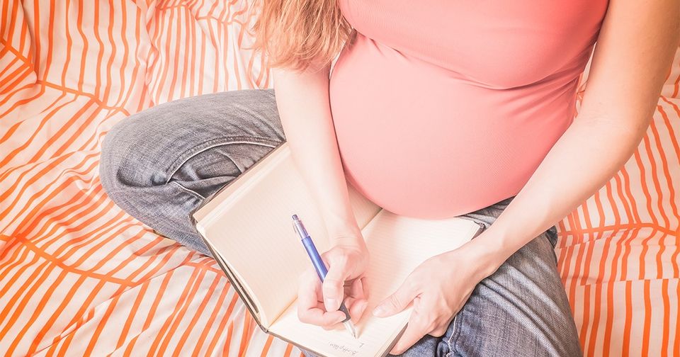 pregnant woman making birth plan on her bed