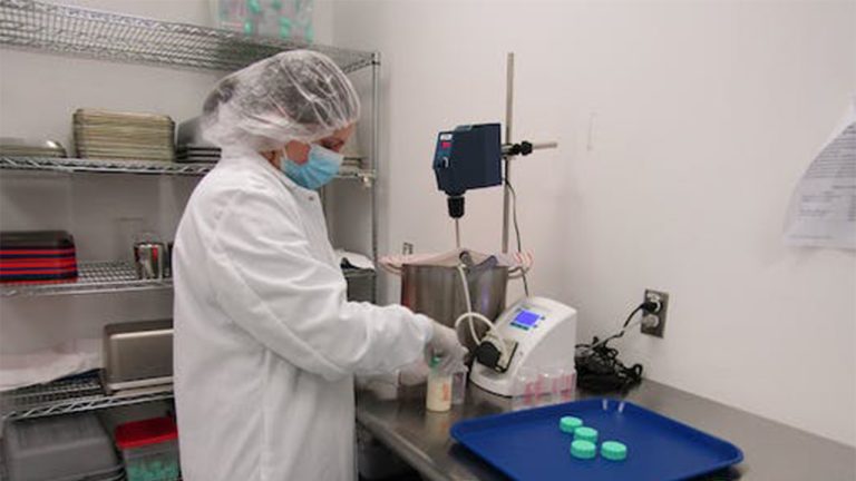 Doctor dispensing breast milk into bottles