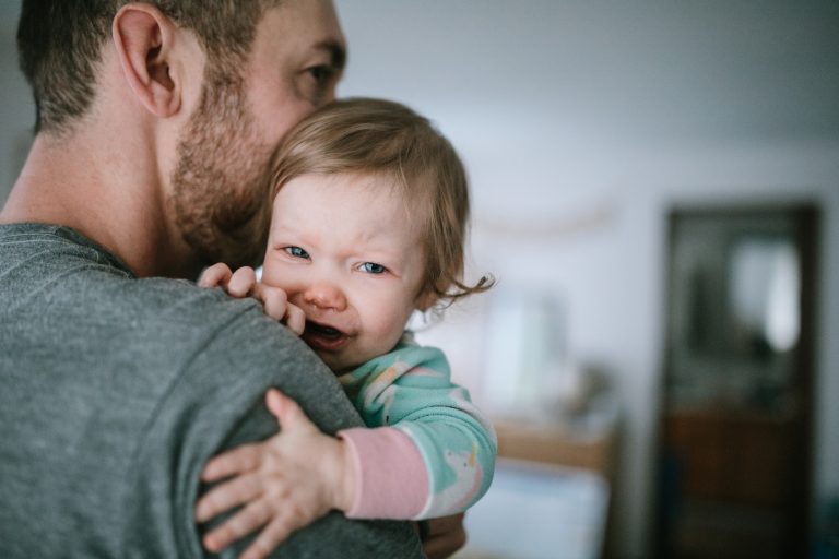 Father Holding Infant Sick With Cold Virus