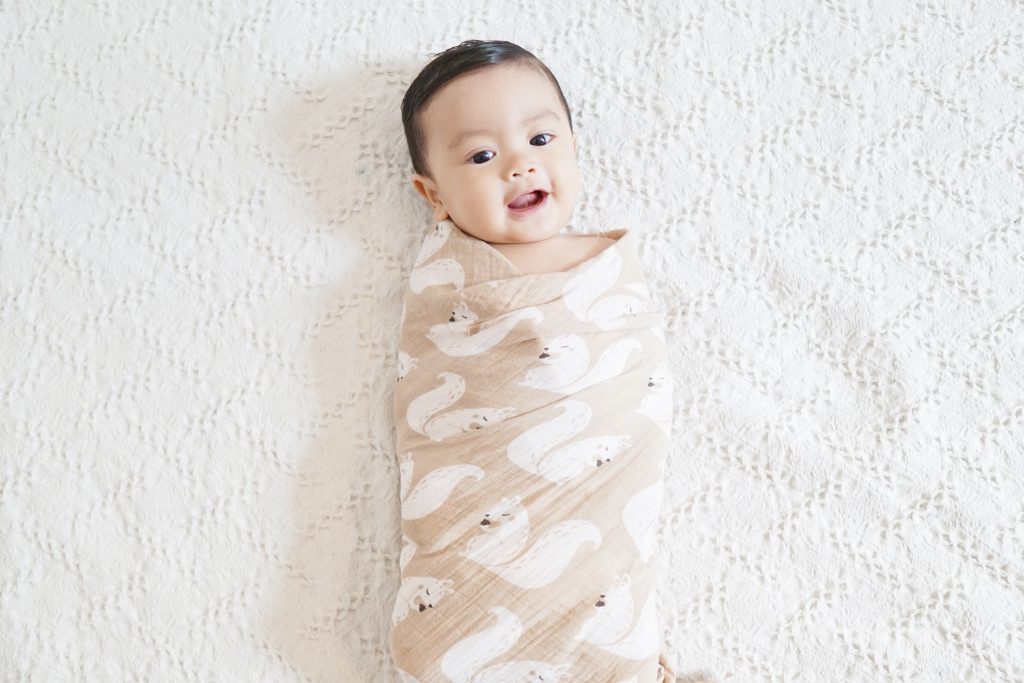 A baby being swaddled