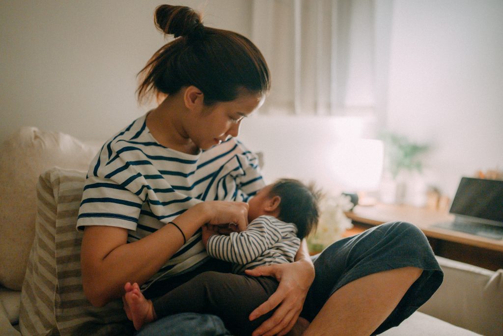 woman breastfeeding while sitting