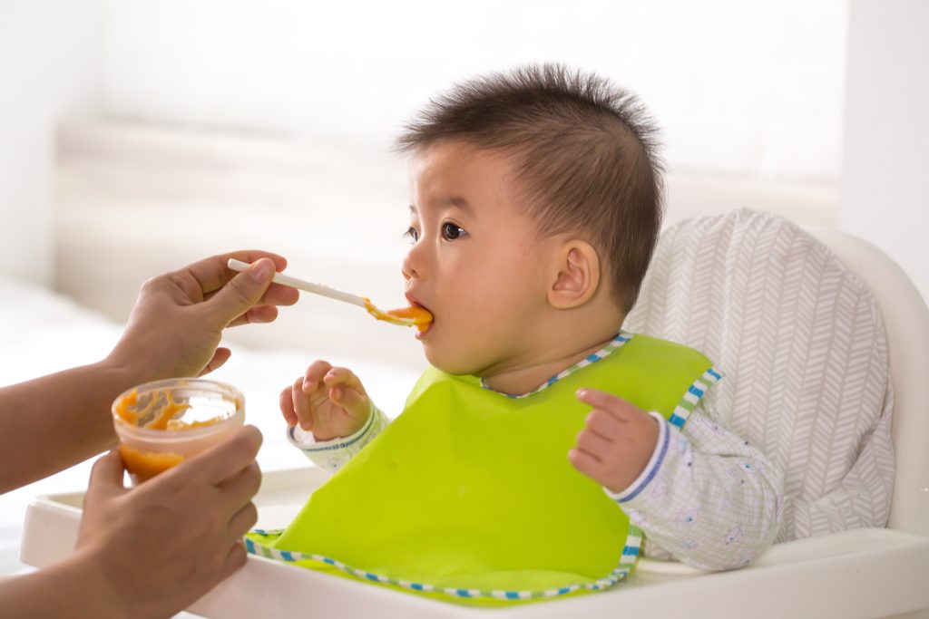 ands Of Mother Feeding Son At Home