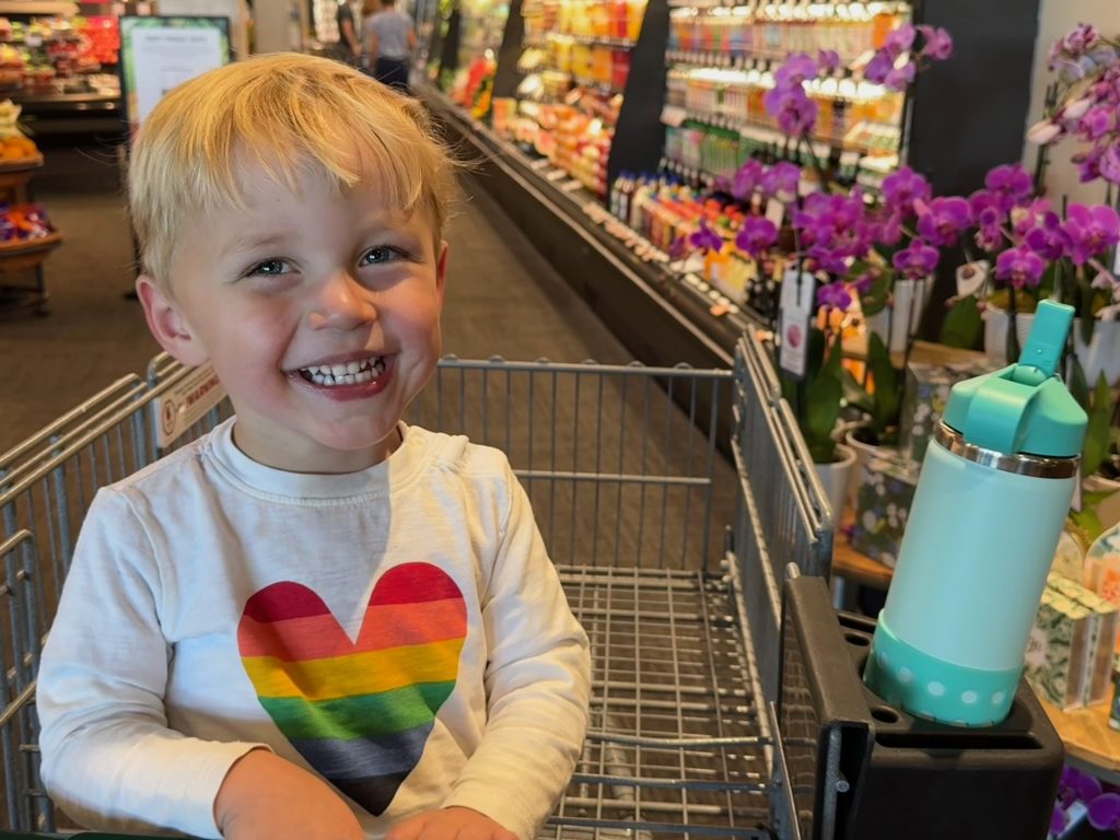 Smiling boy in shopping cart