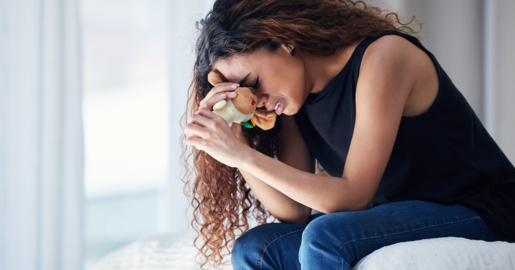 crying woman with baby toy