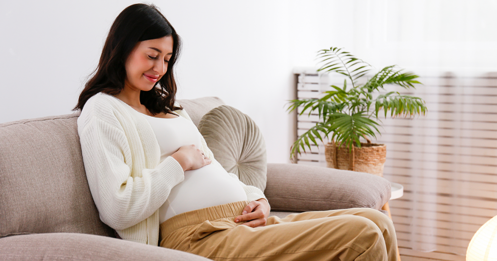 early pregnant woman on couch