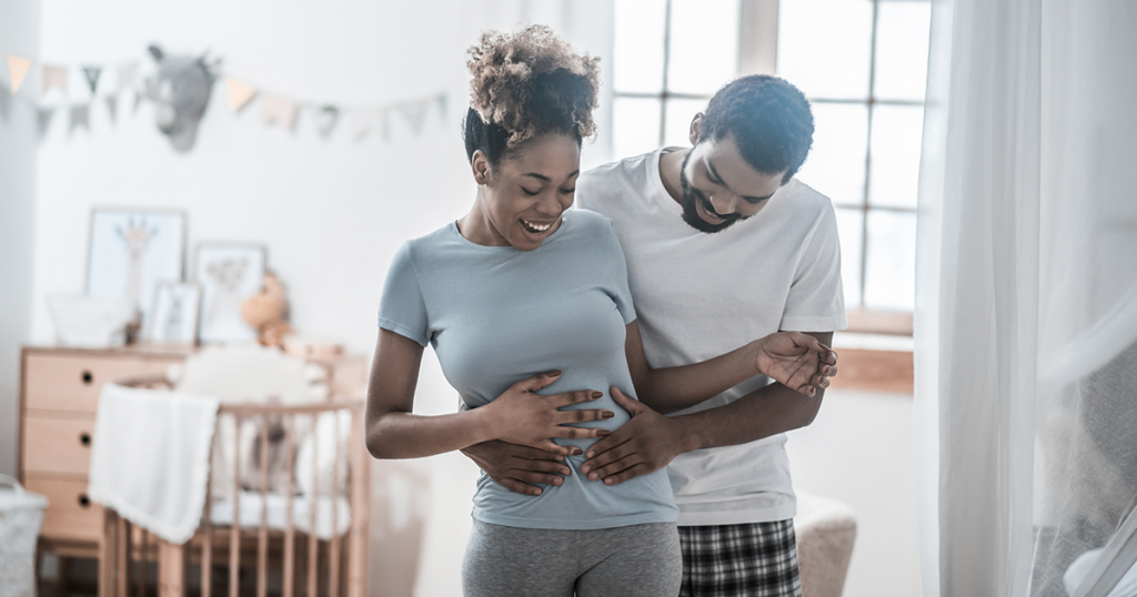 pregnant woman and husband holding her tummy