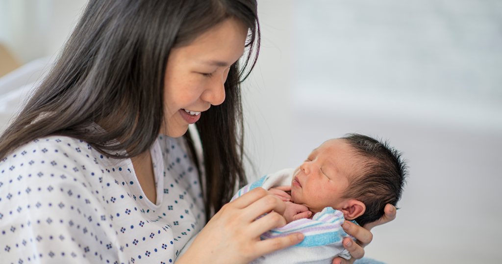 woman holding newborn baby