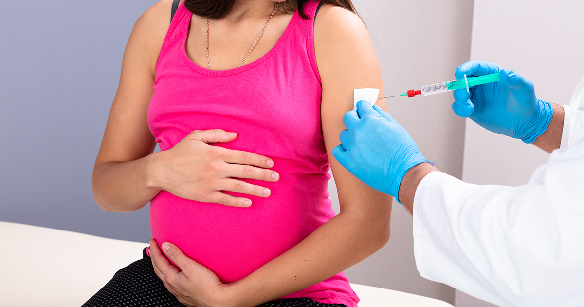 Pregnant woman at a clinic receiving a vaccination