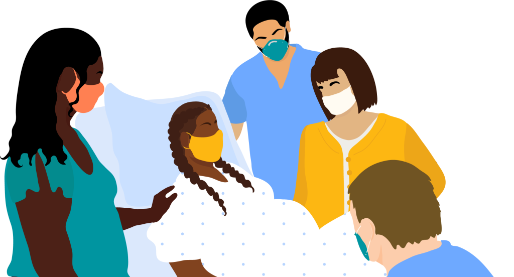 A pregnant person with braids and a mask lays in a hospital bed, surrounded by their female partner and caregivers.